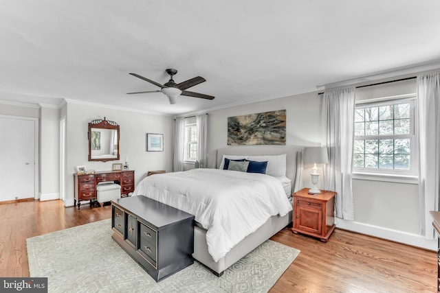 bedroom featuring hardwood / wood-style floors, crown molding, and ceiling fan