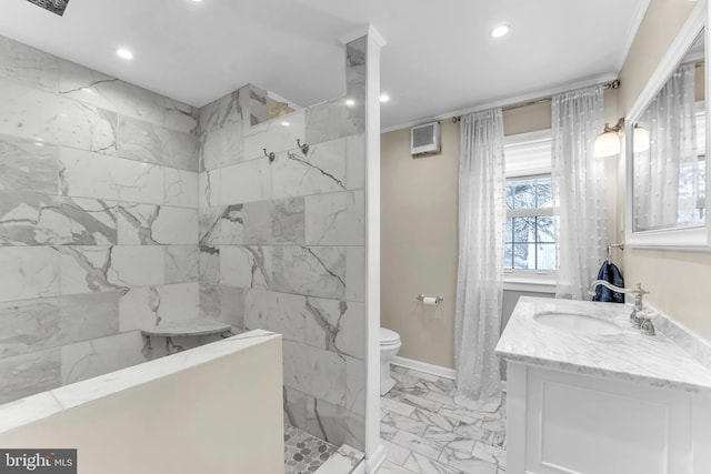 bathroom with vanity, toilet, and a shower