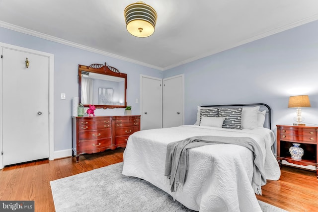 bedroom featuring crown molding and hardwood / wood-style flooring