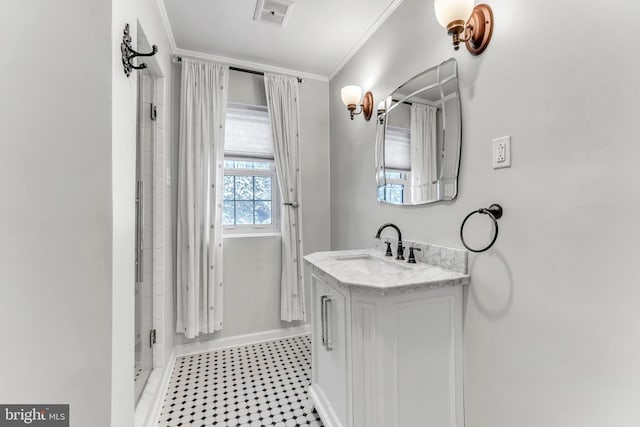 bathroom with crown molding, vanity, and an enclosed shower