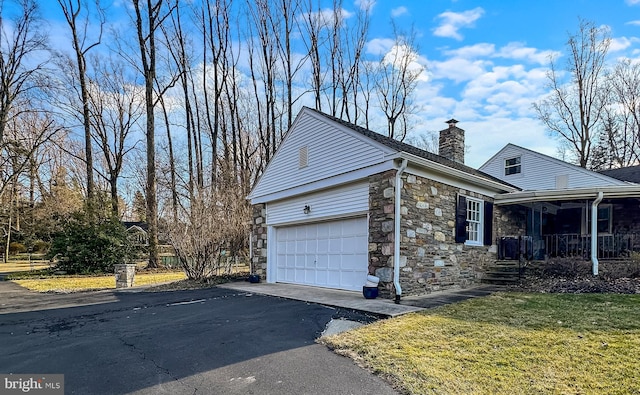 view of home's exterior featuring a garage and a yard