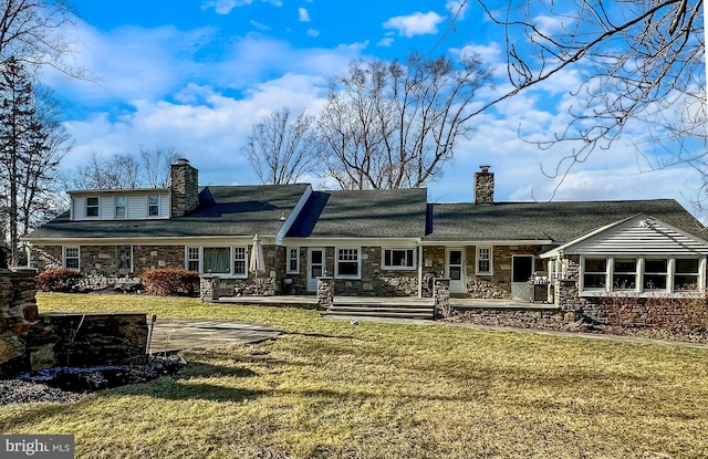 rear view of house with a lawn