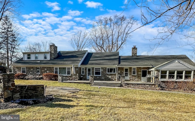 back of house with a lawn