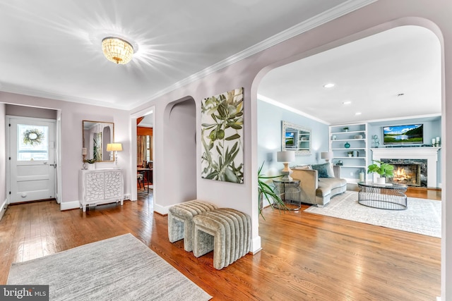 foyer with crown molding and hardwood / wood-style flooring