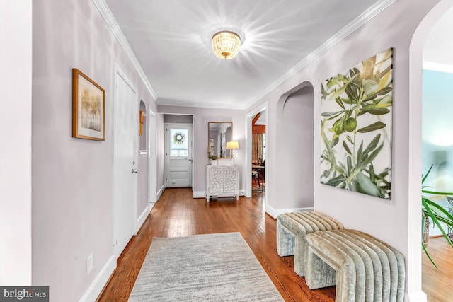 hall with crown molding and wood-type flooring