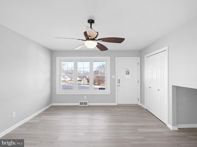 entrance foyer with ceiling fan and light wood-type flooring