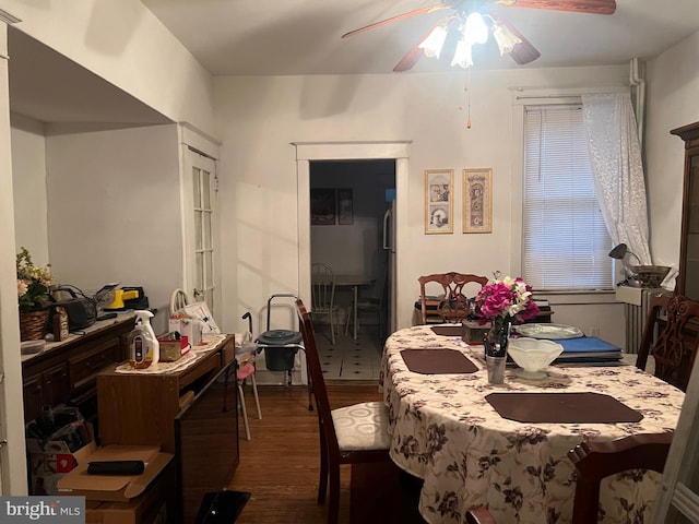 dining area with dark hardwood / wood-style floors and ceiling fan