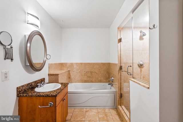 bathroom featuring a garden tub, a stall shower, vanity, and tile patterned flooring