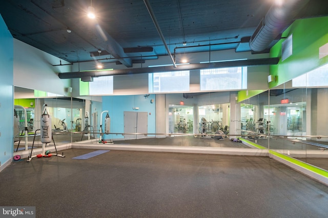 gym featuring a towering ceiling