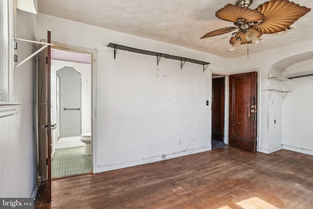 unfurnished room with ceiling fan and dark hardwood / wood-style flooring