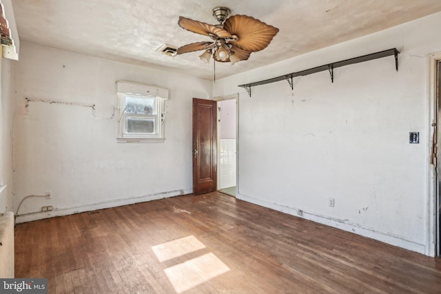 spare room with hardwood / wood-style flooring and ceiling fan