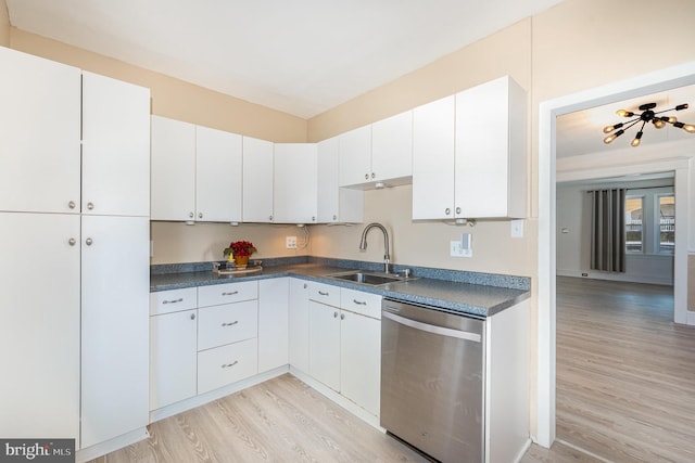 kitchen featuring sink, stainless steel dishwasher, white cabinets, and light hardwood / wood-style flooring