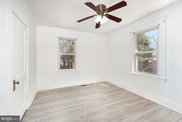 unfurnished room with ceiling fan and light wood-type flooring