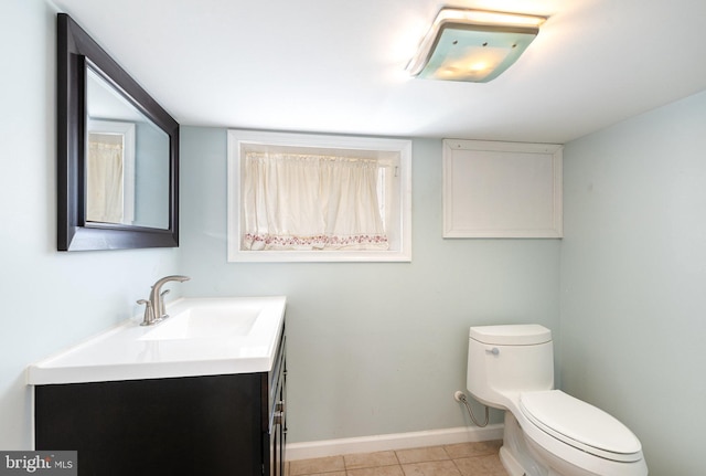 bathroom featuring vanity, tile patterned flooring, and toilet