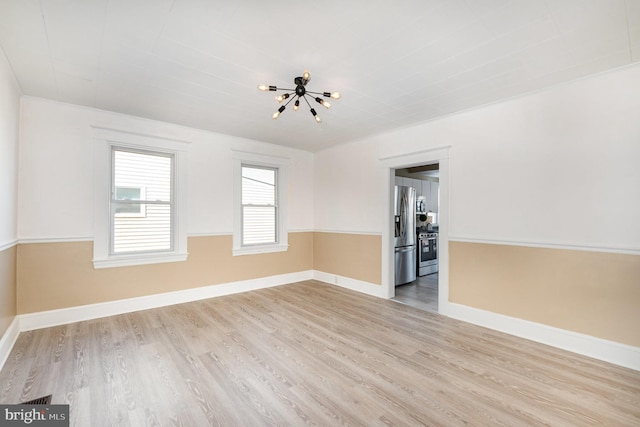 spare room featuring light wood-type flooring