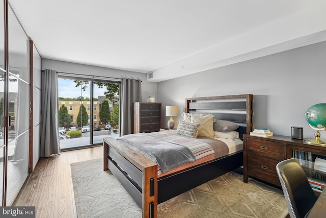 bedroom featuring access to exterior and light hardwood / wood-style floors