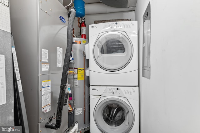 washroom with stacked washing maching and dryer, gas water heater, and heating unit