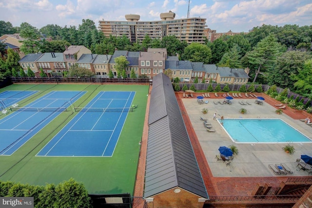 view of sport court featuring a community pool