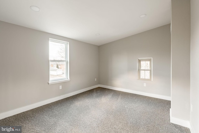 carpeted empty room with a wealth of natural light