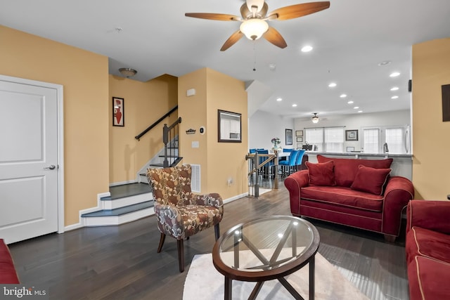 living room featuring dark hardwood / wood-style floors and ceiling fan