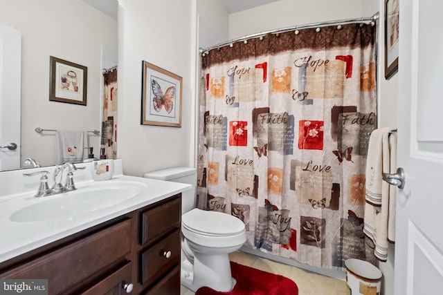 bathroom featuring tile patterned floors, toilet, vanity, and curtained shower