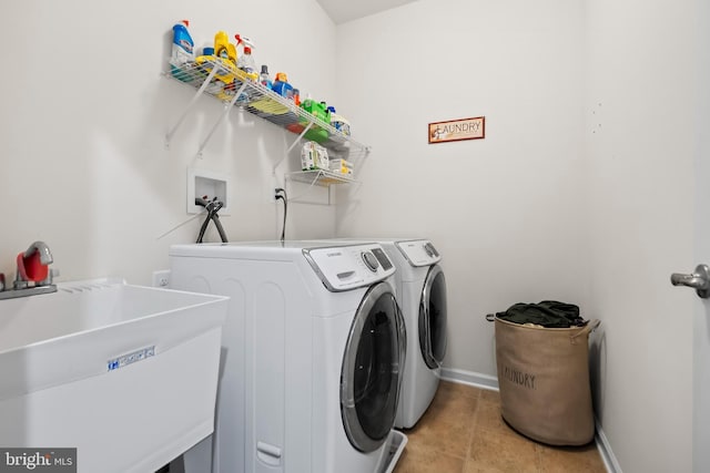 clothes washing area featuring washing machine and dryer and sink