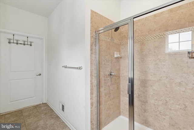 bathroom featuring a shower with shower door