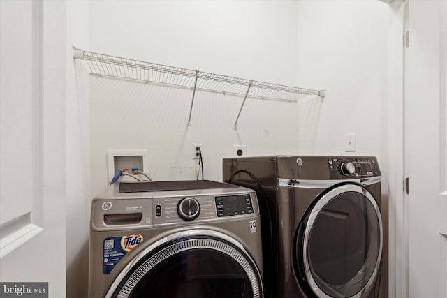 clothes washing area with washer and dryer