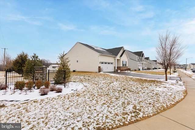 snow covered property featuring a garage