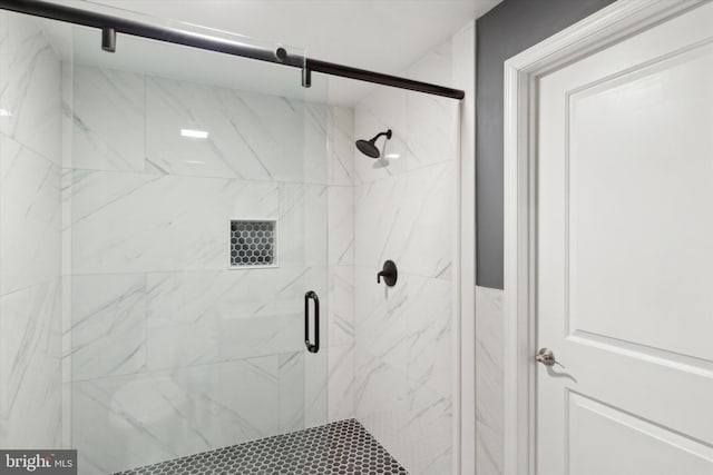 bathroom with a shower with door