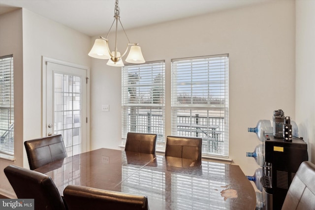 dining area with an inviting chandelier