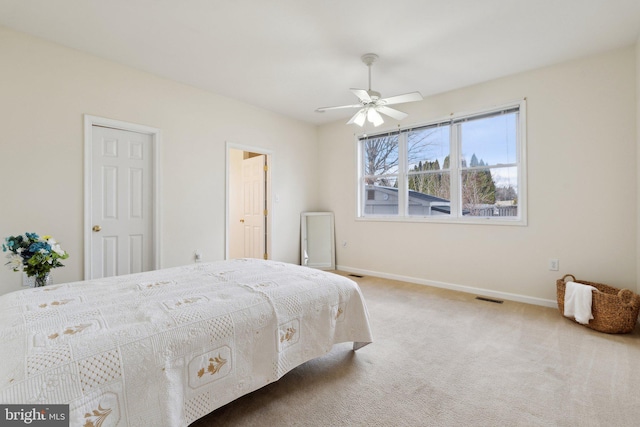 bedroom featuring a ceiling fan, carpet flooring, visible vents, and baseboards