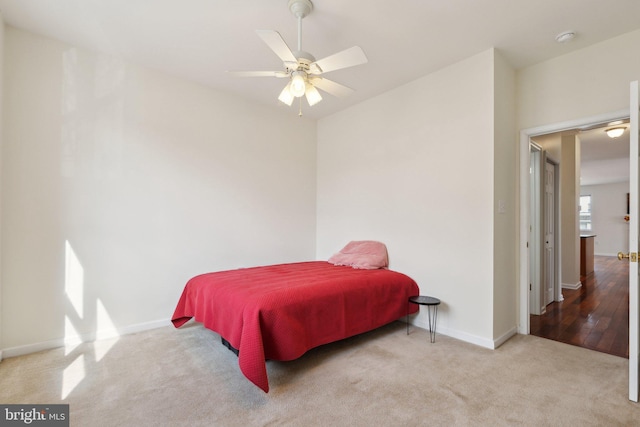 bedroom featuring carpet floors, baseboards, and a ceiling fan