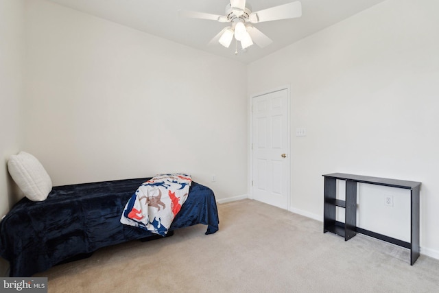 bedroom with light carpet, ceiling fan, and baseboards