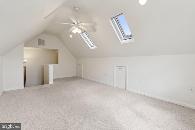 additional living space featuring carpet, visible vents, vaulted ceiling, and baseboards