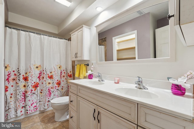 bathroom featuring visible vents, a sink, toilet, and double vanity