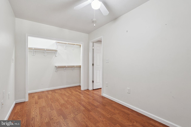 unfurnished bedroom with a ceiling fan, a closet, baseboards, and wood finished floors