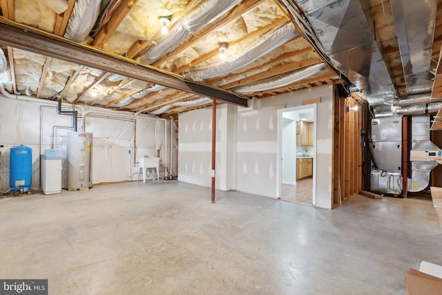 unfinished basement featuring heating unit, water heater, and a sink