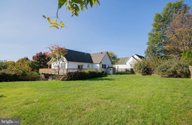 view of yard with fence and a deck