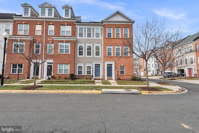 townhome / multi-family property featuring solar panels