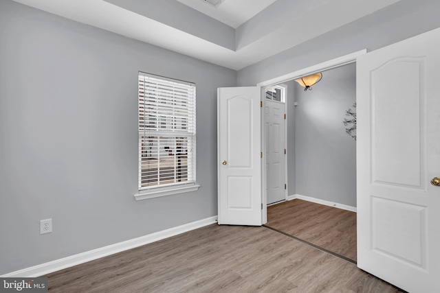 unfurnished bedroom with hardwood / wood-style flooring