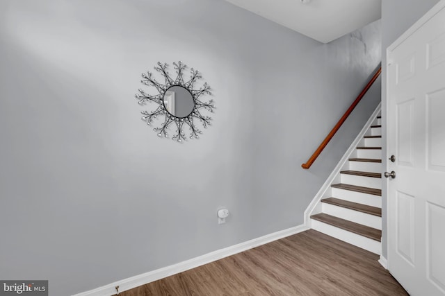 stairway featuring hardwood / wood-style flooring