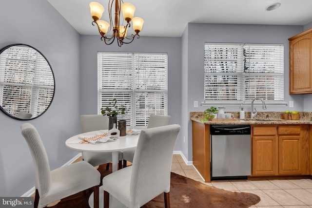 tiled dining room featuring an inviting chandelier and sink