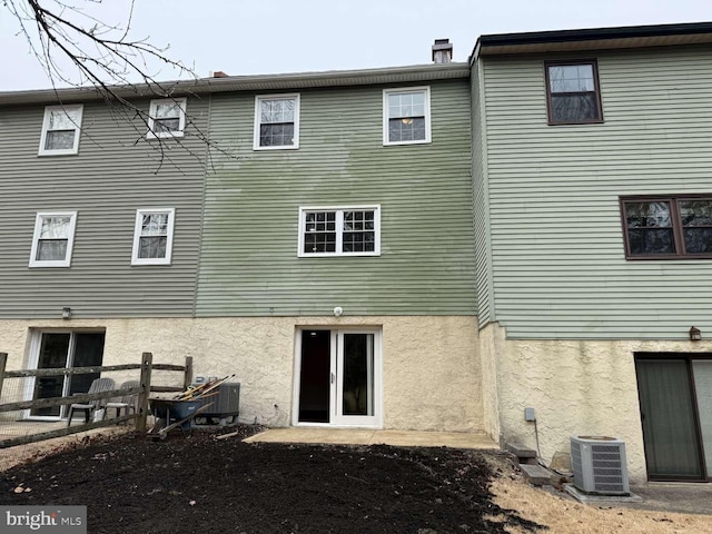 back of house featuring cooling unit