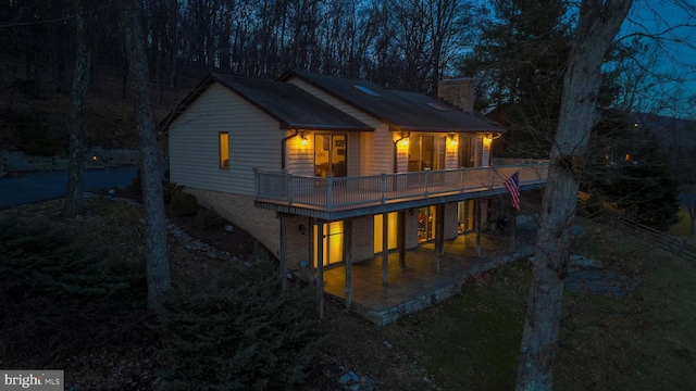 rear view of house featuring a deck