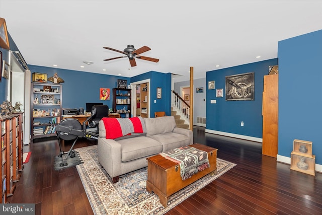 living room with ceiling fan and dark hardwood / wood-style floors