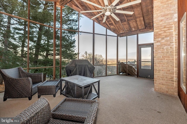 sunroom / solarium with lofted ceiling, wood ceiling, and ceiling fan