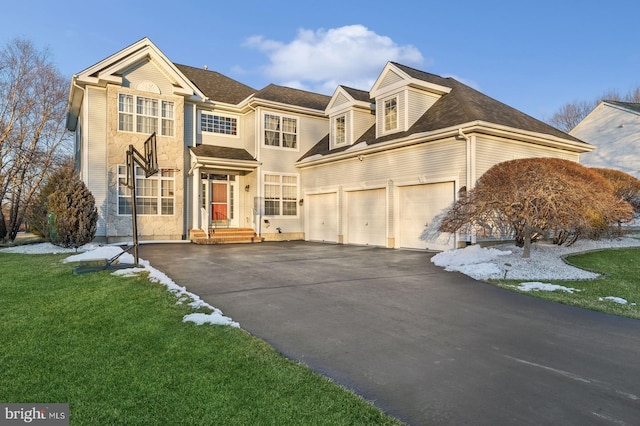 view of front of property with a garage and a front yard