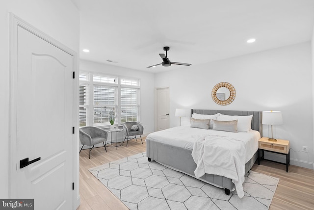 bedroom featuring light wood-style floors, recessed lighting, visible vents, and baseboards