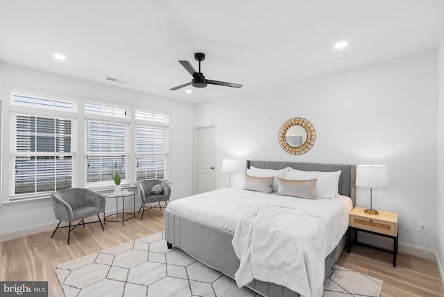 bedroom featuring recessed lighting, visible vents, light wood-style flooring, and baseboards